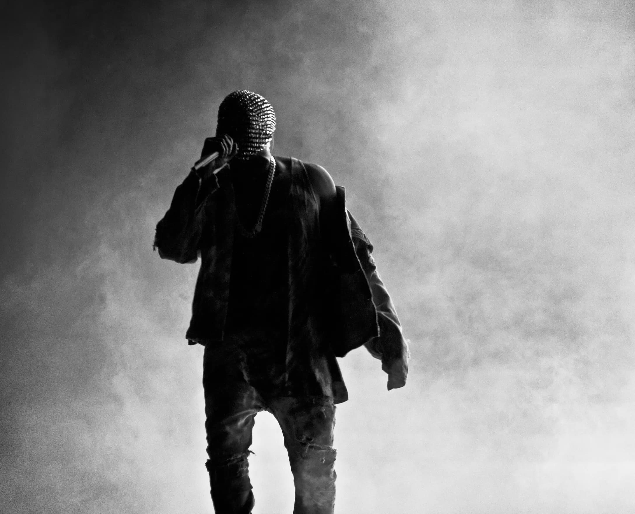 Ye on stage in a crystal mask, in black and white, on a past tour