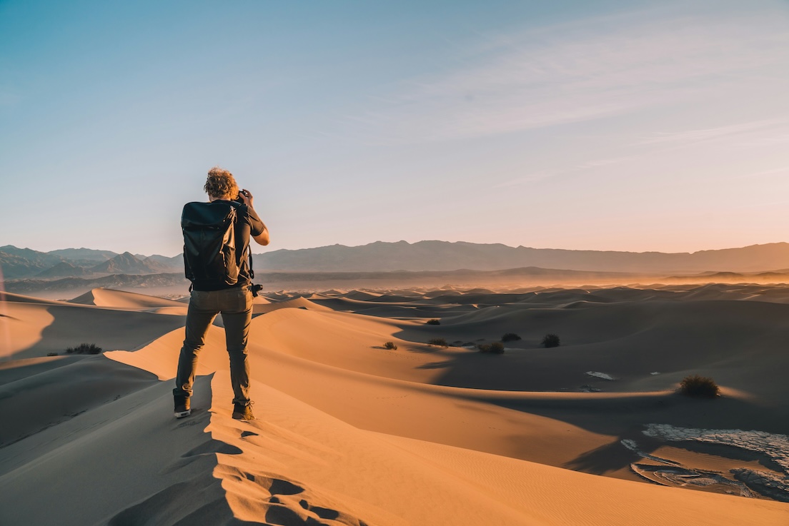 A traveller using their phone abroad — the moment a Roamly eSIM covers.